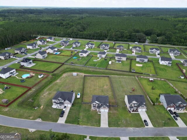 358 Brookhaven Loop NE, Ludowici, GA 31316 - aerial view of residential area featuring a heavily wooded area