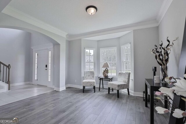 358 Brookhaven Loop NE, Ludowici, GA 31316 - entryway with arched walkways, stairway, ornamental molding, and wood finished floors