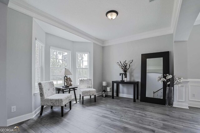 358 Brookhaven Loop NE, Ludowici, GA 31316 - living area featuring wood finished floors and crown molding