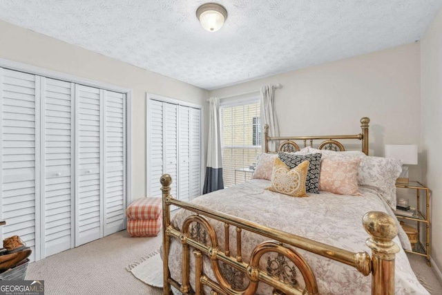 3115 Seven Pines Ct Unit 308, Atlanta, GA 30339 - carpeted bedroom with two closets and a textured ceiling