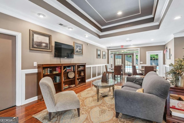 3115 Seven Pines Ct Unit 308, Atlanta, GA 30339 - living area featuring french doors, wood finished floors, a tray ceiling, crown molding, and wainscoting
