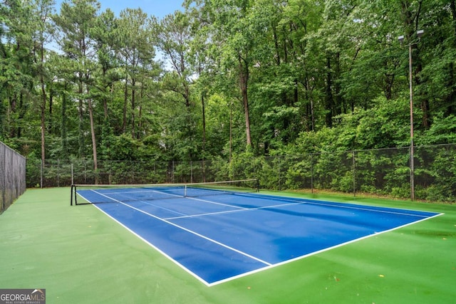 3115 Seven Pines Ct Unit 308, Atlanta, GA 30339 - view of tennis court featuring a wooded view