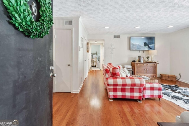 3115 Seven Pines Ct Unit 308, Atlanta, GA 30339 - living area with wood finished floors, a textured ceiling, and recessed lighting