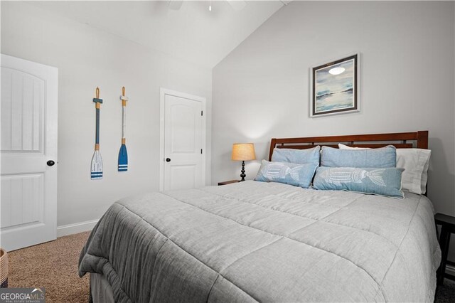 509 Mariners Cir, Saint Simons, GA 31522 - carpeted bedroom featuring vaulted ceiling and a ceiling fan