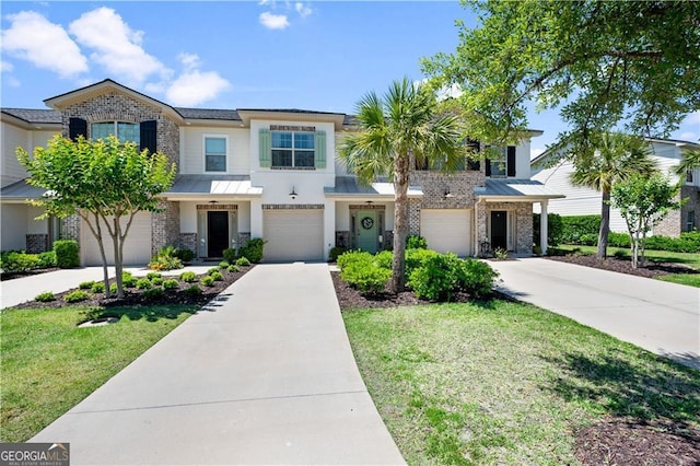 509 Mariners Cir, Saint Simons, GA 31522 - view of front facade featuring driveway, an attached garage, brick siding, and a standing seam roof