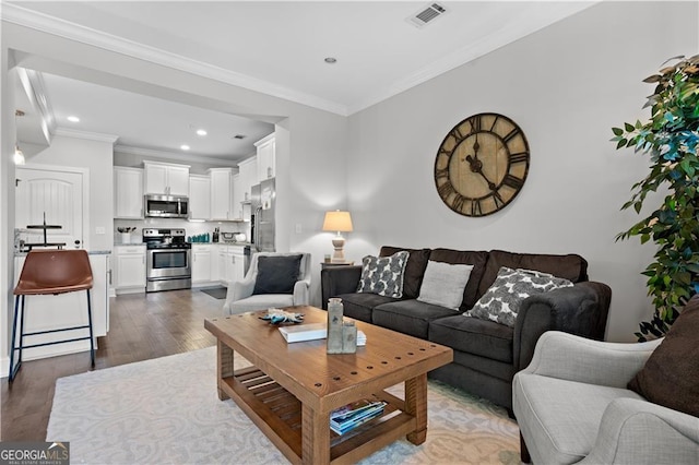 509 Mariners Cir, Saint Simons, GA 31522 - living room featuring wood finished floors, recessed lighting, and crown molding
