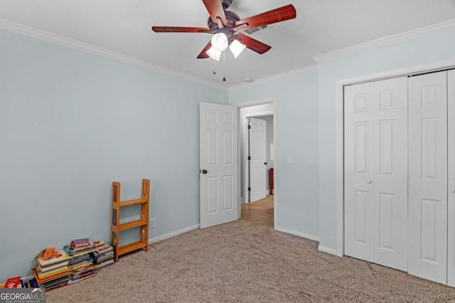 1207 College Ave, Blackshear, GA 31516 - unfurnished bedroom with carpet, ornamental molding, a closet, and a ceiling fan