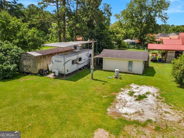 1207 College Ave, Blackshear, GA 31516 - view of green lawn featuring a storage unit