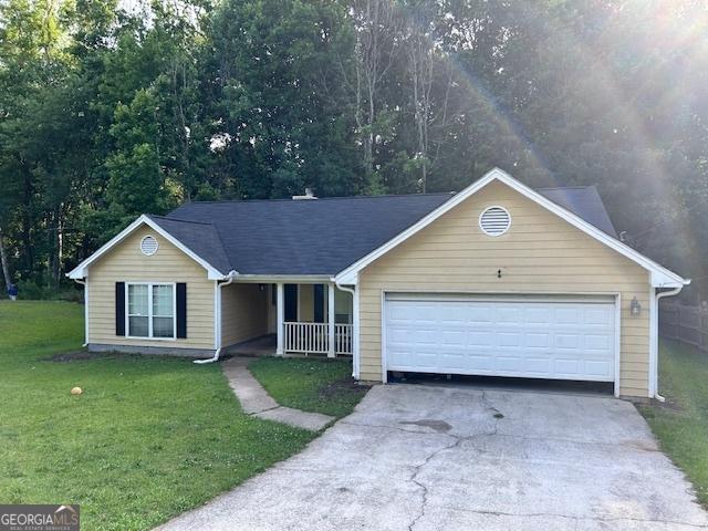 8519 Glenwoods Dr, Riverdale, GA 30274 - ranch-style home featuring a porch, driveway, a front lawn, and an attached garage