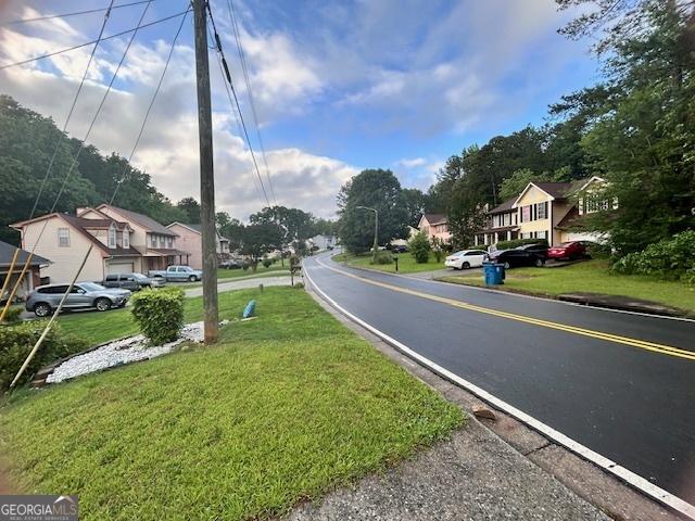 8519 Glenwoods Dr, Riverdale, GA 30274 - view of asphalt street with a residential view and street lights