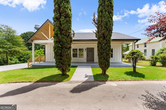 130 E Railroad Ave, Alto, GA 30510 - view of front of home featuring board and batten siding, covered porch, and a front lawn