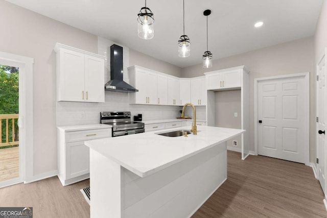 130 E Railroad Ave, Alto, GA 30510 - kitchen featuring electric stove, wall chimney exhaust hood, light wood-style flooring, tasteful backsplash, and white cabinetry