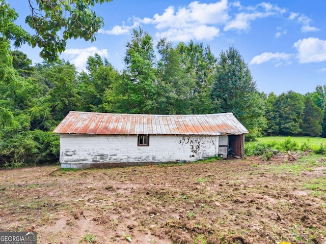 130 E Railroad Ave, Alto, GA 30510 - view of property exterior with a wooded view, a metal roof, and an outbuilding
