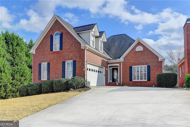 2324 Blackberry Ct, Snellville, GA 30078 - traditional-style home with concrete driveway, brick siding, a front yard, and roof with shingles