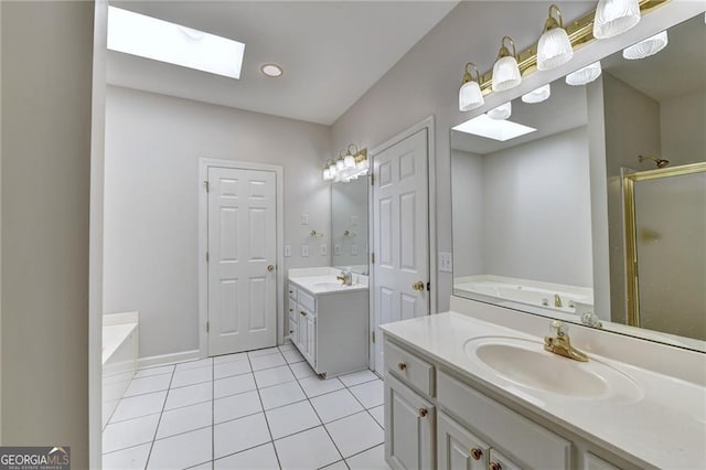 2324 Blackberry Ct, Snellville, GA 30078 - full bath with a skylight, two vanities, a garden tub, and a shower stall