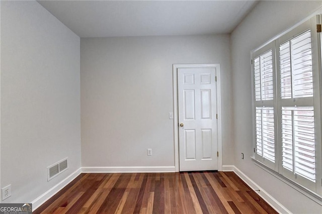 2324 Blackberry Ct, Snellville, GA 30078 - unfurnished bedroom with dark wood-type flooring and baseboards