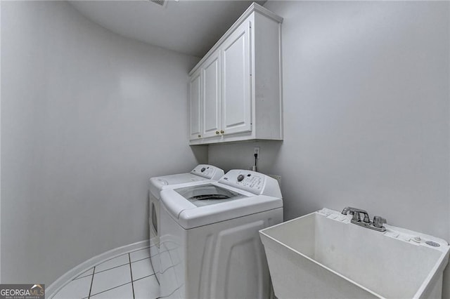 2324 Blackberry Ct, Snellville, GA 30078 - laundry area with independent washer and dryer, cabinet space, and light tile patterned floors