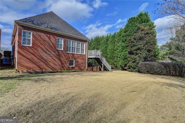 2324 Blackberry Ct, Snellville, GA 30078 - back of house featuring brick siding, roof with shingles, stairs, a lawn, and a deck