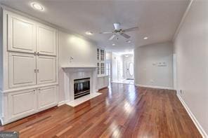 2324 Blackberry Ct, Snellville, GA 30078 - unfurnished living room with a glass covered fireplace, ceiling fan, wood finished floors, and recessed lighting