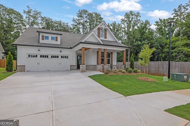 153 Alaina Rd, Holly Springs, GA 30115 - view of front facade with a porch, concrete driveway, board and batten siding, and brick siding