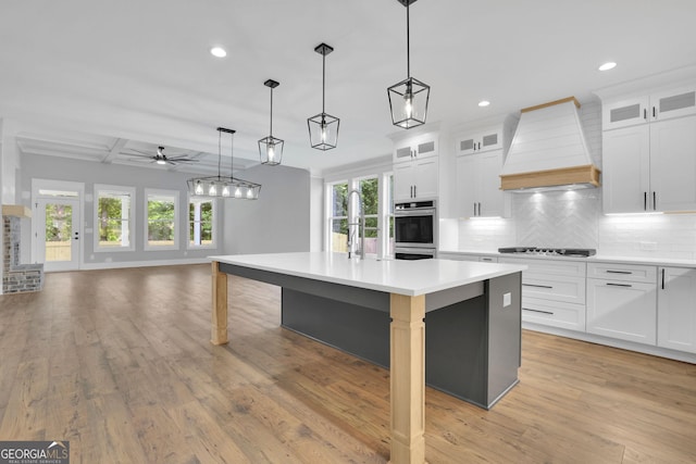 153 Alaina Rd, Holly Springs, GA 30115 - kitchen with custom exhaust hood, a ceiling fan, plenty of natural light, backsplash, and recessed lighting