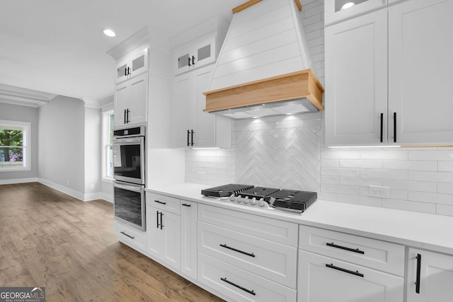 153 Alaina Rd, Holly Springs, GA 30115 - kitchen featuring appliances with stainless steel finishes, custom exhaust hood, light countertops, backsplash, and recessed lighting