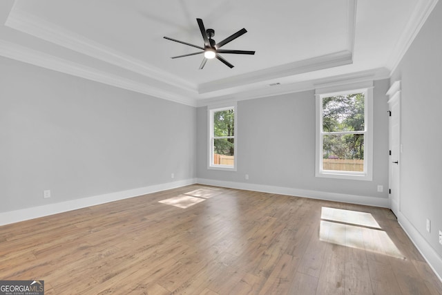153 Alaina Rd, Holly Springs, GA 30115 - empty room featuring a raised ceiling, ornamental molding, hardwood / wood-style flooring, and a ceiling fan