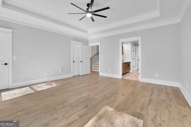 153 Alaina Rd, Holly Springs, GA 30115 - unfurnished bedroom with ornamental molding, light wood-style floors, a tray ceiling, ceiling fan, and ensuite bath