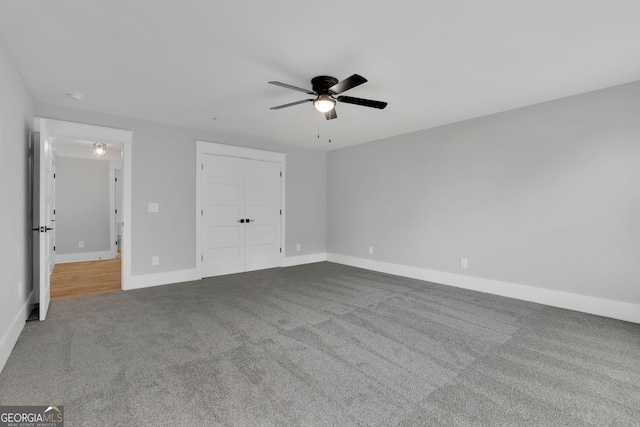 153 Alaina Rd, Holly Springs, GA 30115 - unfurnished bedroom featuring carpet flooring, a ceiling fan, and a closet