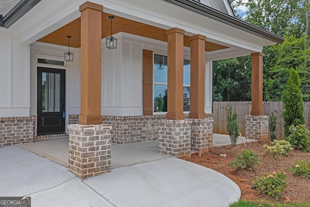 153 Alaina Rd, Holly Springs, GA 30115 - entrance to property with covered porch, board and batten siding, and brick siding
