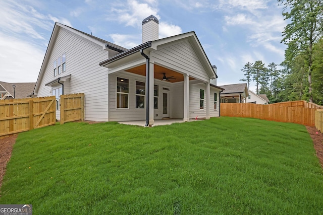 153 Alaina Rd, Holly Springs, GA 30115 - back of house with a ceiling fan, a gate, a patio area, a fenced backyard, and a chimney
