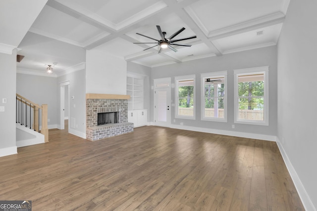 153 Alaina Rd, Holly Springs, GA 30115 - unfurnished living room featuring a ceiling fan, wood-type flooring, beamed ceiling, stairs, and a fireplace