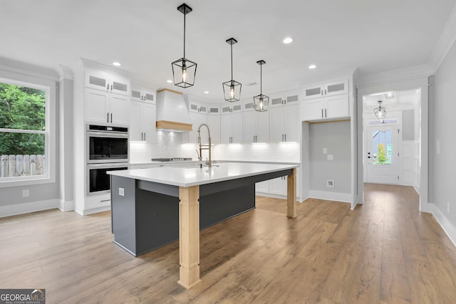 153 Alaina Rd, Holly Springs, GA 30115 - kitchen with custom exhaust hood, double oven, black electric stovetop, ornamental molding, and tasteful backsplash