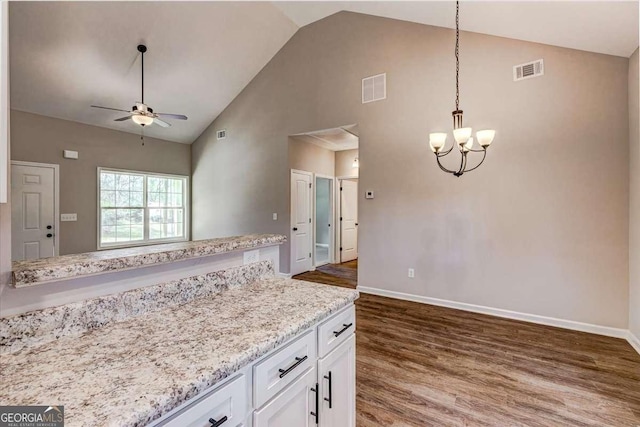 211 Loftis Rd, Temple, GA 30179 - kitchen with high vaulted ceiling, wood finished floors, white cabinets, ceiling fan, and a chandelier