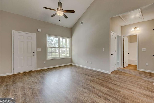 211 Loftis Rd, Temple, GA 30179 - unfurnished living room featuring attic access, wood finished floors, ceiling fan, and high vaulted ceiling