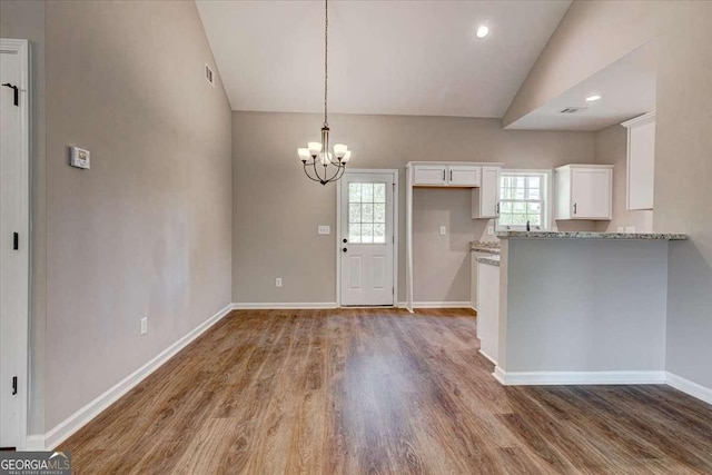 211 Loftis Rd, Temple, GA 30179 - kitchen featuring white cabinets, lofted ceiling, plenty of natural light, wood finished floors, and a chandelier