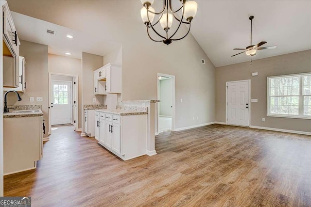 211 Loftis Rd, Temple, GA 30179 - kitchen featuring a ceiling fan, open floor plan, white cabinets, light wood-style flooring, and high vaulted ceiling