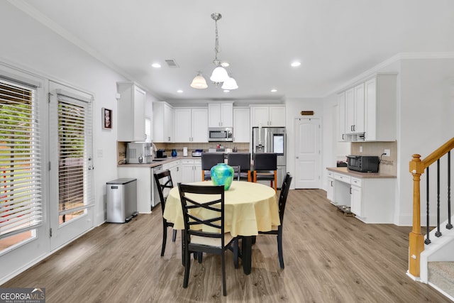 425 Eldridge Dr, Suwanee, GA 30024 - dining space with stairway, a chandelier, light wood finished floors, ornamental molding, and recessed lighting