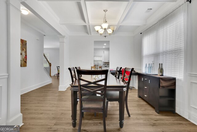 425 Eldridge Dr, Suwanee, GA 30024 - dining room featuring coffered ceiling, a chandelier, light wood-type flooring, beamed ceiling, and decorative columns