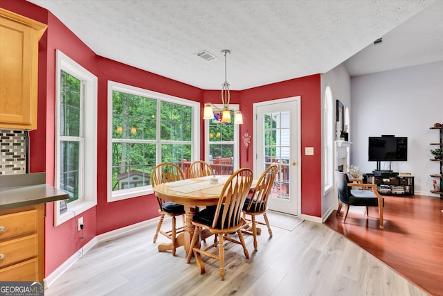 52 Cherub Ln, Sharpsburg, GA 30277 - dining room featuring light wood finished floors and a textured ceiling