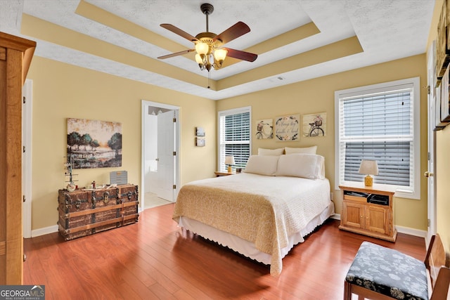 52 Cherub Ln, Sharpsburg, GA 30277 - bedroom featuring a raised ceiling, dark wood finished floors, and ceiling fan