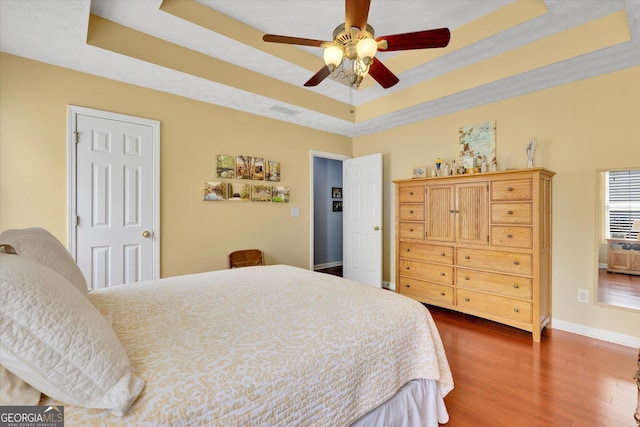 52 Cherub Ln, Sharpsburg, GA 30277 - bedroom with a tray ceiling, dark wood-type flooring, and ceiling fan