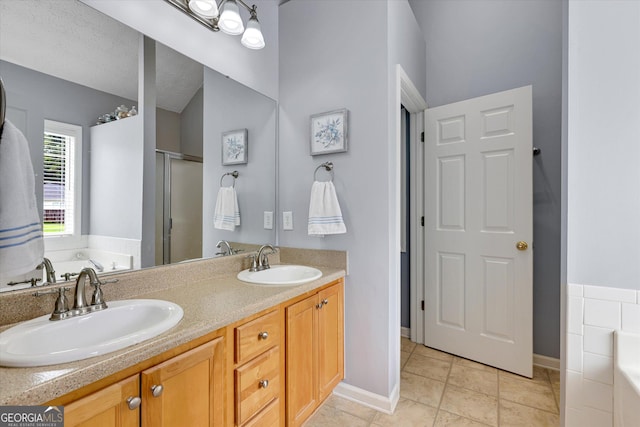 52 Cherub Ln, Sharpsburg, GA 30277 - bathroom with a garden tub, double vanity, a shower stall, and tile patterned flooring