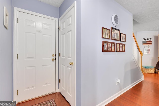52 Cherub Ln, Sharpsburg, GA 30277 - corridor with a textured ceiling, wood finished floors, and stairway