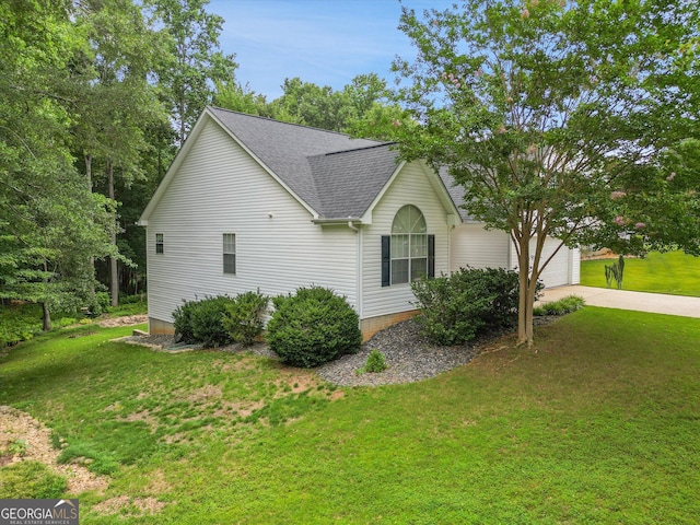 52 Cherub Ln, Sharpsburg, GA 30277 - view of side of home with roof with shingles, driveway, an attached garage, and a lawn