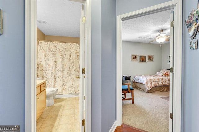 52 Cherub Ln, Sharpsburg, GA 30277 - full bathroom with vanity, a ceiling fan, a textured ceiling, ensuite bath, and curtained shower