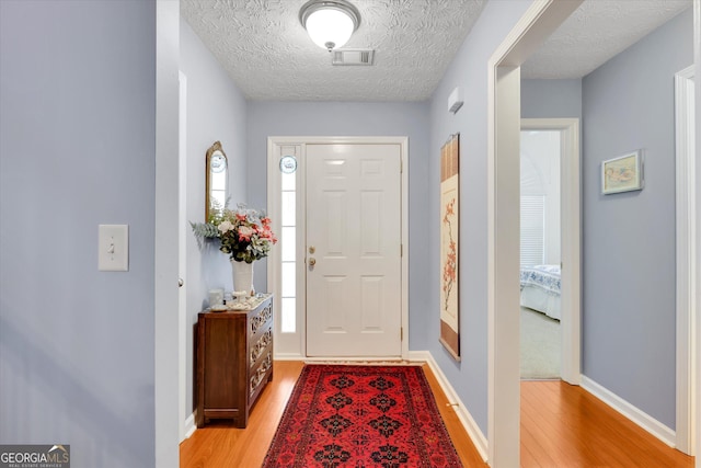 52 Cherub Ln, Sharpsburg, GA 30277 - foyer with light wood-type flooring and a textured ceiling
