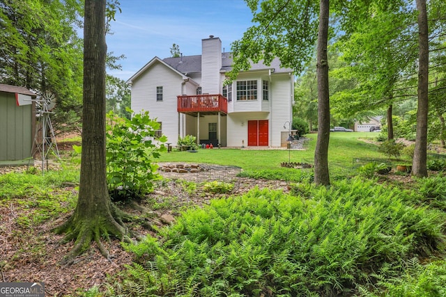 52 Cherub Ln, Sharpsburg, GA 30277 - back of property with a deck, a lawn, and a chimney