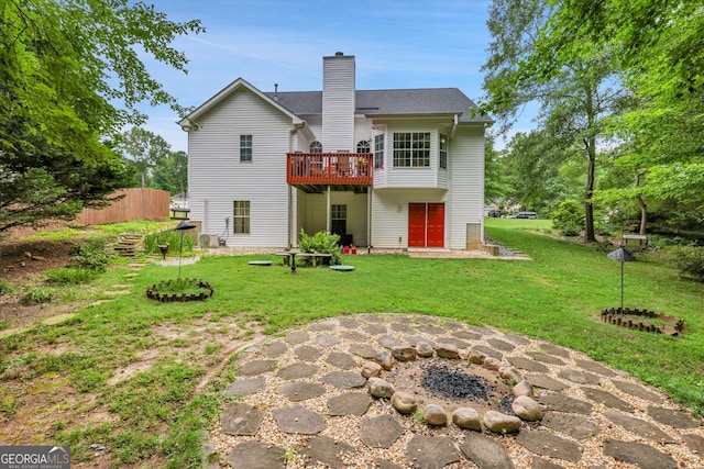 52 Cherub Ln, Sharpsburg, GA 30277 - back of house featuring a deck, a chimney, and a yard