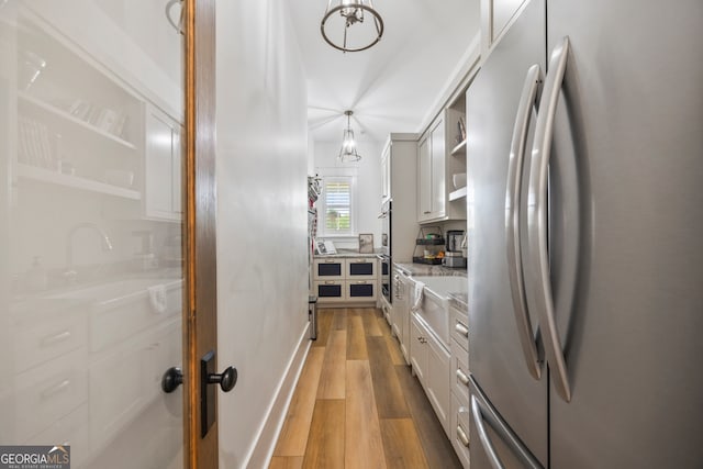 639 Frank Crook Rd, Canon, GA 30520 - kitchen featuring appliances with stainless steel finishes, light wood-style flooring, open shelves, white cabinetry, and light stone counters